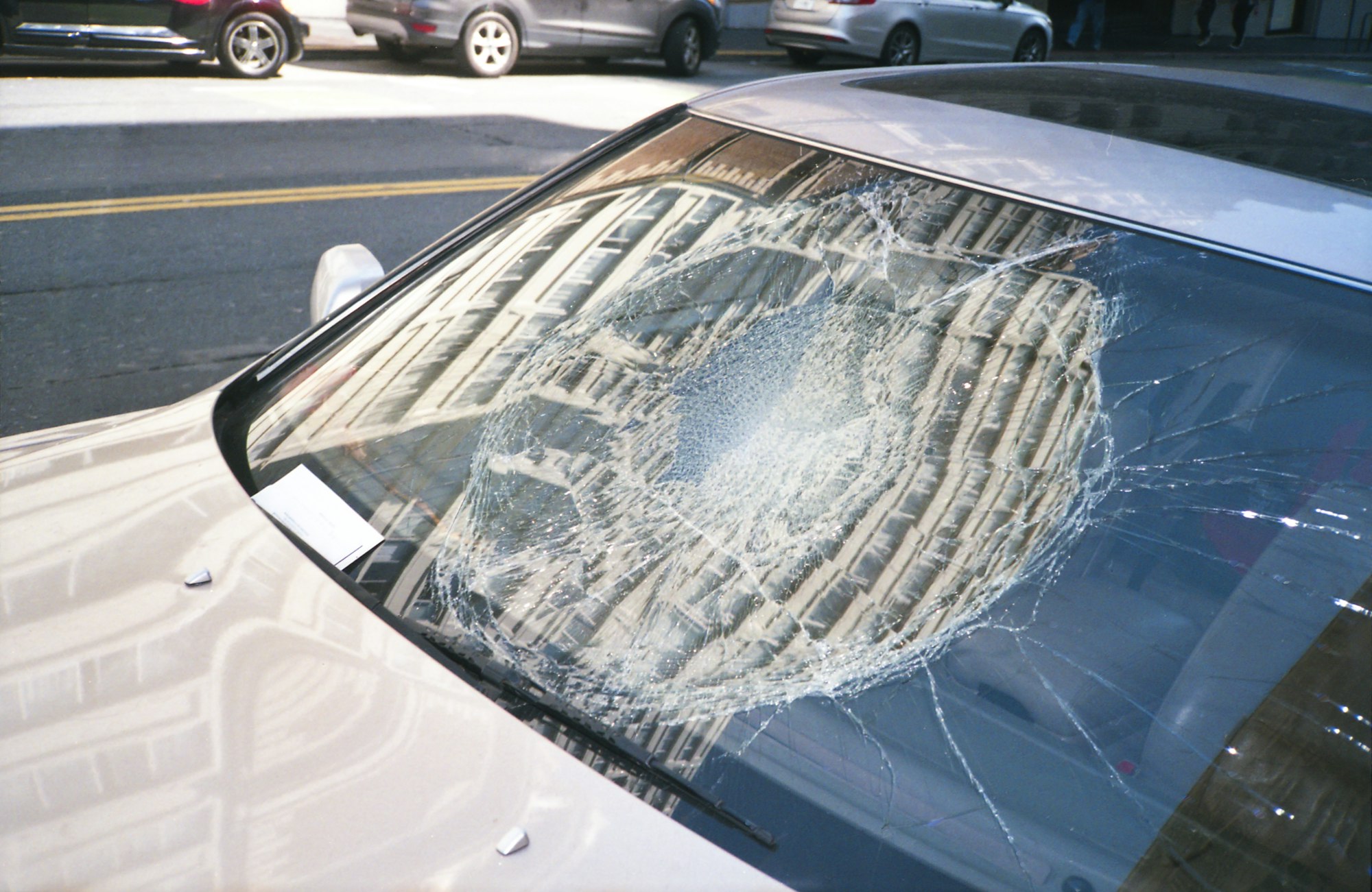 Shattered windshield after a serious auto accident on a Los Angeles street, illustrating Noble Attorneys' car accident practice
